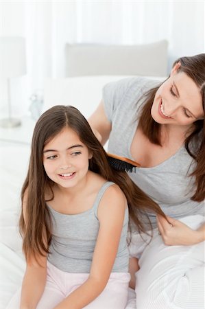 family bathroom mirror - Woman brushing her daughter hair at home Stock Photo - Budget Royalty-Free & Subscription, Code: 400-04300913