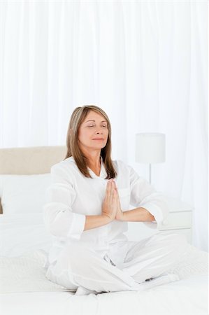 Senior practicing yoga on her bed at home Stock Photo - Budget Royalty-Free & Subscription, Code: 400-04302028