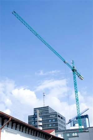 tower crane working on construction on blue sky background Stock Photo - Budget Royalty-Free & Subscription, Code: 400-04303826