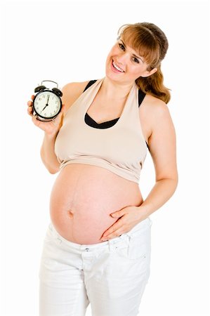simsearch:400-04817039,k - Baby on way! Smiling pregnant woman holding alarm clock isolated on white Stock Photo - Budget Royalty-Free & Subscription, Code: 400-04315967