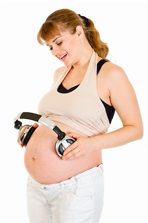 simsearch:400-04817039,k - Happy pregnant woman holding headphones on her tummy isolated on white Stock Photo - Budget Royalty-Free & Subscription, Code: 400-04315970