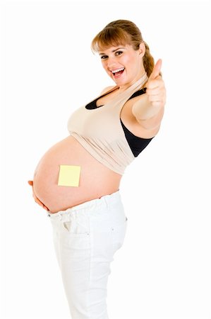 simsearch:400-04798379,k - Smiling pregnant woman with blank sticky note on her belly showing thumbs up gesture isolated on white Stock Photo - Budget Royalty-Free & Subscription, Code: 400-04315983