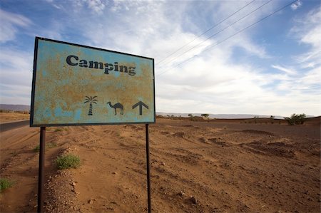 Sign on a desert road to give direction to a campsite in Morocco Stock Photo - Budget Royalty-Free & Subscription, Code: 400-04316156