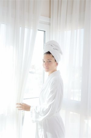 simsearch:400-04335125,k - Bathrobe happy woman sunny hotel window white curtains Stock Photo - Budget Royalty-Free & Subscription, Code: 400-04319290