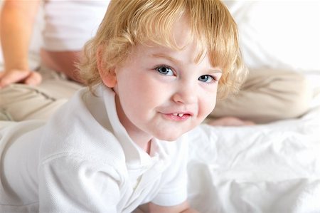 Young boy playing and having fun in mothers white bed Stock Photo - Budget Royalty-Free & Subscription, Code: 400-04310248