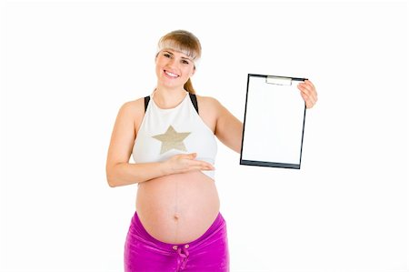 simsearch:400-04798379,k - Smiling beautiful pregnant woman pointing on blank clipboard isolated on white Stock Photo - Budget Royalty-Free & Subscription, Code: 400-04310622