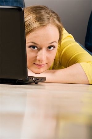 plump girls - young lying woman is working on laptop on floor Stock Photo - Budget Royalty-Free & Subscription, Code: 400-04325526