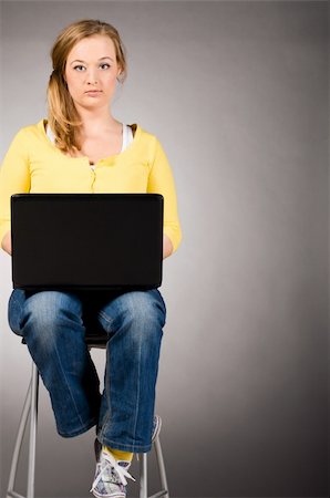 plump girls - young woman is working on laptop sitting on high chair Stock Photo - Budget Royalty-Free & Subscription, Code: 400-04325531