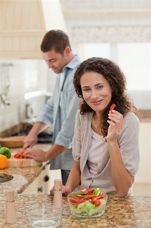simsearch:400-05744780,k - Woman eating while her husband is cooking at home Stock Photo - Budget Royalty-Free & Subscription, Code: 400-04325587