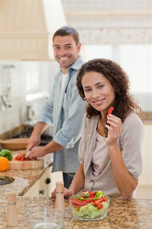 simsearch:400-05744780,k - Woman eating while her husband is cooking at home Stock Photo - Budget Royalty-Free & Subscription, Code: 400-04325588