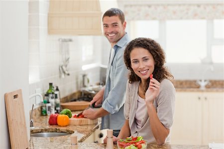 simsearch:400-05744780,k - Woman eating while her husband is cooking at home Stock Photo - Budget Royalty-Free & Subscription, Code: 400-04325592