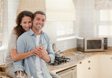 simsearch:400-05744780,k - Beautiful couple hugging in the kitchen at home Stock Photo - Budget Royalty-Free & Subscription, Code: 400-04325696