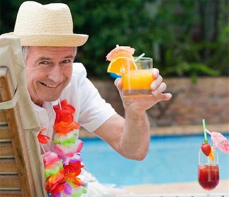 Mature man drinking a cocktail beside the swimming poo Stock Photo - Budget Royalty-Free & Subscription, Code: 400-04326547