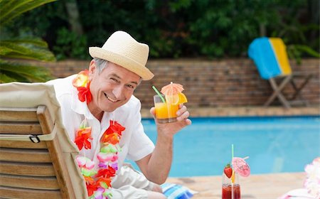 Mature man drinking a cocktail beside the swimming poo Stock Photo - Budget Royalty-Free & Subscription, Code: 400-04326552