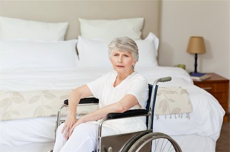 Concentrated senior woman in her wheelchair at home Stock Photo - Budget Royalty-Free & Subscription, Code: 400-04326688