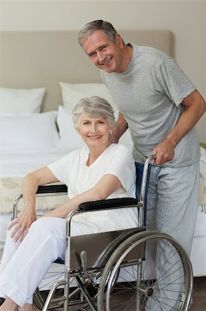 Retired woman in her wheelchair with her husband Stock Photo - Budget Royalty-Free & Subscription, Code: 400-04326702