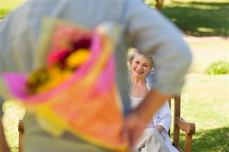 Mature man offering flowers to his wife Stock Photo - Budget Royalty-Free & Subscription, Code: 400-04327710