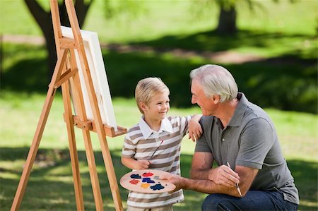 Grandfather and his grandson painting in the garden Stock Photo - Budget Royalty-Free & Subscription, Code: 400-04327795