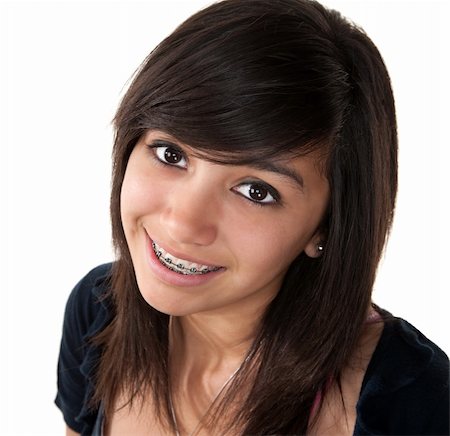 Cute Latina teenage girl smiling with braces on a white background Photographie de stock - Aubaine LD & Abonnement, Code: 400-04328009