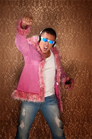 Native American Man in pink jacket enjoys to music from his MP3 player Stock Photo - Budget Royalty-Free & Subscription, Code: 400-04328043