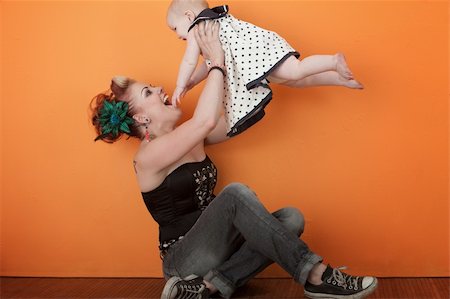 Young happy Caucasian mom in a playful mood with baby Stock Photo - Budget Royalty-Free & Subscription, Code: 400-04328135