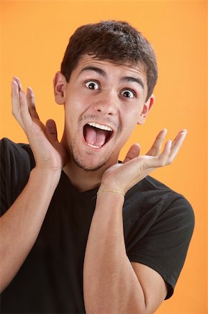 Young Latino man is very excited with hands near head Foto de stock - Super Valor sin royalties y Suscripción, Código: 400-04328149