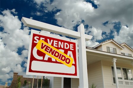 simsearch:693-03308239,k - Vendido Se Vende Casa Spanish Real Estate Sign and House and Blue Sky with Clouds. Stock Photo - Budget Royalty-Free & Subscription, Code: 400-04329170