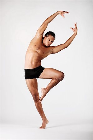 fit black boy - Young male dancer posing over grey background. Stock Photo - Budget Royalty-Free & Subscription, Code: 400-04320836