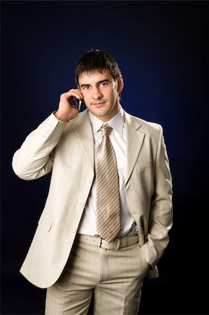 Businessman talking on cell phone over dark background Photographie de stock - Aubaine LD & Abonnement, Code: 400-04322264