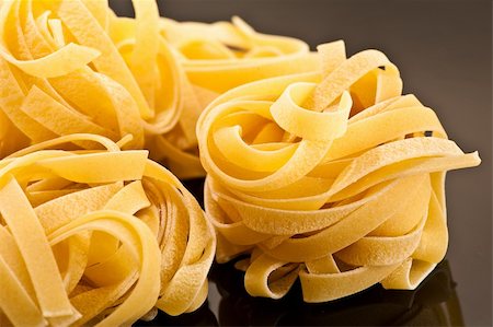Italian raw pasta on a black plate Stock Photo - Budget Royalty-Free & Subscription, Code: 400-04335134