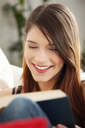 simsearch:400-04418460,k - Beautiful woman reading a book, sitting on a sofa in a living-room Stock Photo - Budget Royalty-Free & Subscription, Code: 400-04335853