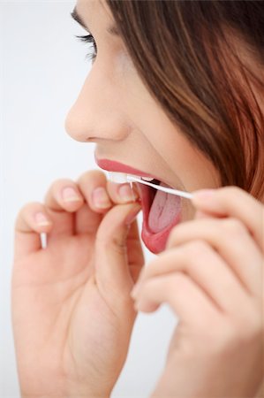 Beautiful young woman using dental floss at bathroom Photographie de stock - Aubaine LD & Abonnement, Code: 400-04335953