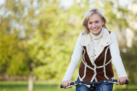 simsearch:400-05755734,k - Attractive young girl on a bicycle in the park Photographie de stock - Aubaine LD & Abonnement, Code: 400-04336559