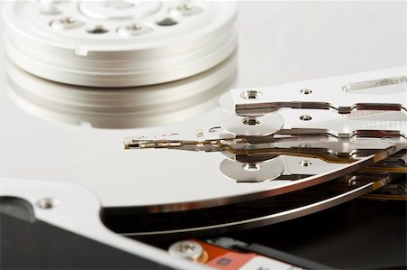 simsearch:400-05252692,k - Closeup of the platters and head of a opened computer hard drive Stock Photo - Budget Royalty-Free & Subscription, Code: 400-04337596