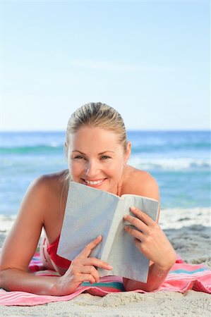 Adorable woman reading a book on the beach Stock Photo - Budget Royalty-Free & Subscription, Code: 400-04337782