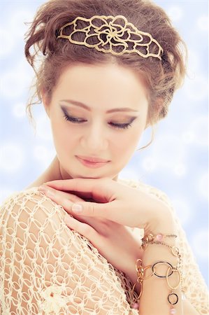 simsearch:400-04754019,k - Young shy woman in a diadem and bracelets of gold on abstract background. Stock Photo - Budget Royalty-Free & Subscription, Code: 400-04338148