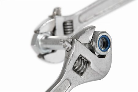 The image of the wrench which is turning off a nut from a bolt, isolated, on a white background Foto de stock - Super Valor sin royalties y Suscripción, Código: 400-04339744