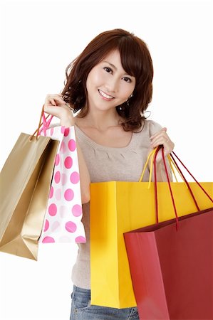 Smiling shopping woman of Asian, closeup portrait of young lady holding bags on white background. Stock Photo - Budget Royalty-Free & Subscription, Code: 400-04333022