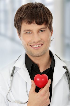simsearch:400-07222508,k - Handsome young male doctor holding heart shape toy Photographie de stock - Aubaine LD & Abonnement, Code: 400-04333687