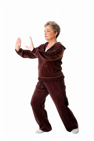 Beautiful Senior woman doing Tai Chi exercise to keep her joints flexible, isolated. Stock Photo - Budget Royalty-Free & Subscription, Code: 400-04344218