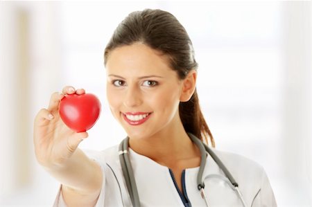 Young nurse with heart in her hand Stock Photo - Budget Royalty-Free & Subscription, Code: 400-04346211
