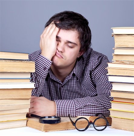 The young tired student with the books isolated. Studio shot. Stock Photo - Budget Royalty-Free & Subscription, Code: 400-04346643