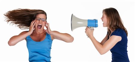 girl shouting into a megaphone to another girls face Stock Photo - Budget Royalty-Free & Subscription, Code: 400-04347159