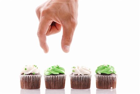 favorite - Hand About to Pick a Cup Cake to Eat Stock Photo - Budget Royalty-Free & Subscription, Code: 400-04347941