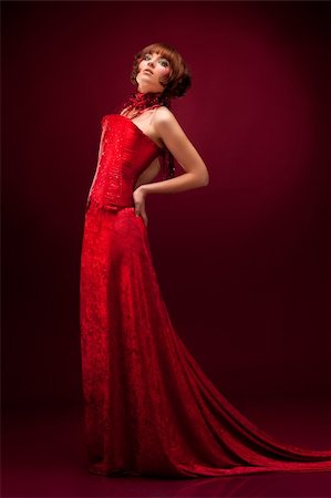 simsearch:400-04653285,k - Beautiful girl in red dress over on red background Photographie de stock - Aubaine LD & Abonnement, Code: 400-04349106