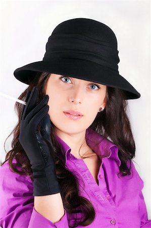 simsearch:400-05693792,k - Portrait of a beautiful brunette young woman with black hat and cigar Stock Photo - Budget Royalty-Free & Subscription, Code: 400-04349848