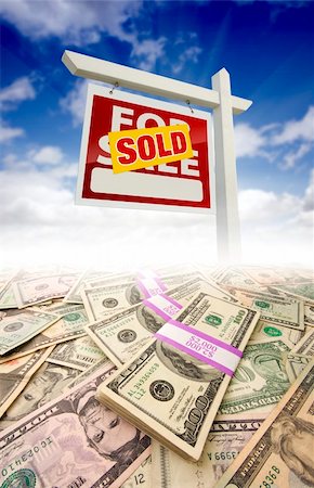 sold sign - Stacks of Money Fading Off and Sold For Sale Real Estate Sign Against Blue Sky with Clouds. Stock Photo - Budget Royalty-Free & Subscription, Code: 400-04341913