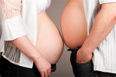 man and pregnant woman is showing their bellies, side view Foto de stock - Super Valor sin royalties y Suscripción, Código: 400-04358906