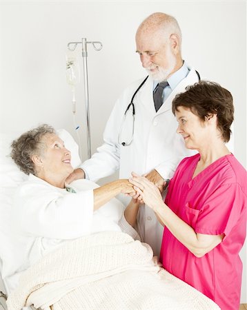 Attentive doctor and nurse caring for an elderly hospital patient. Stock Photo - Budget Royalty-Free & Subscription, Code: 400-04364234