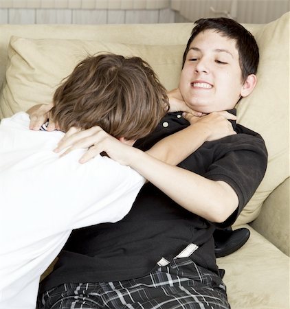 Two brothers playfully fighting on the couch. Stock Photo - Budget Royalty-Free & Subscription, Code: 400-04364236